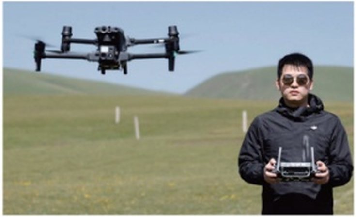 Pilot with remote controller on open ground